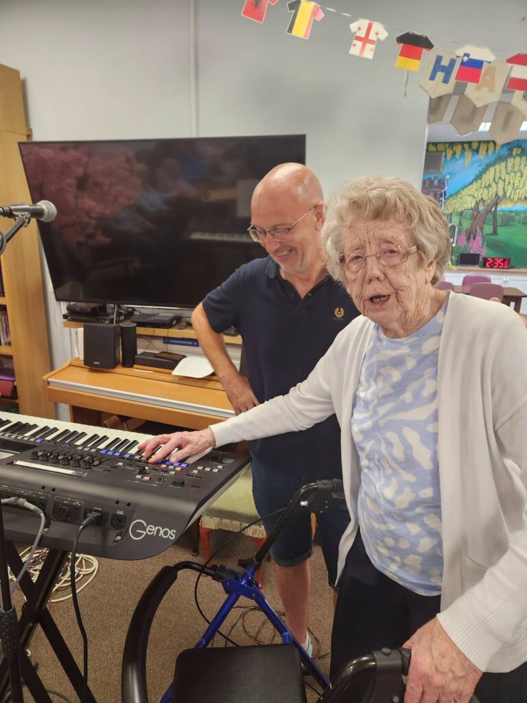 Jean enjoying music at Harlawhill Day Care Centre