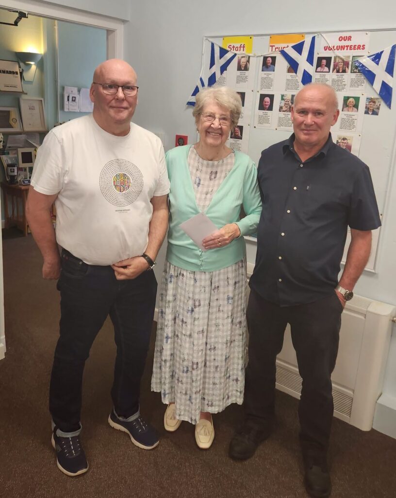Donation of £800 from Castlepark Bowling Club in memory of the Cunningham family presented by Robert and David Cunningham to Betty Merritt