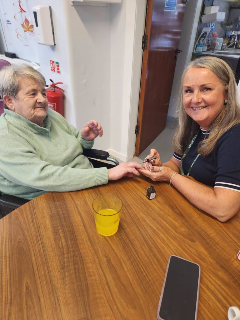 Volunteer Linda gives Harlawhill member Anne a manicure.